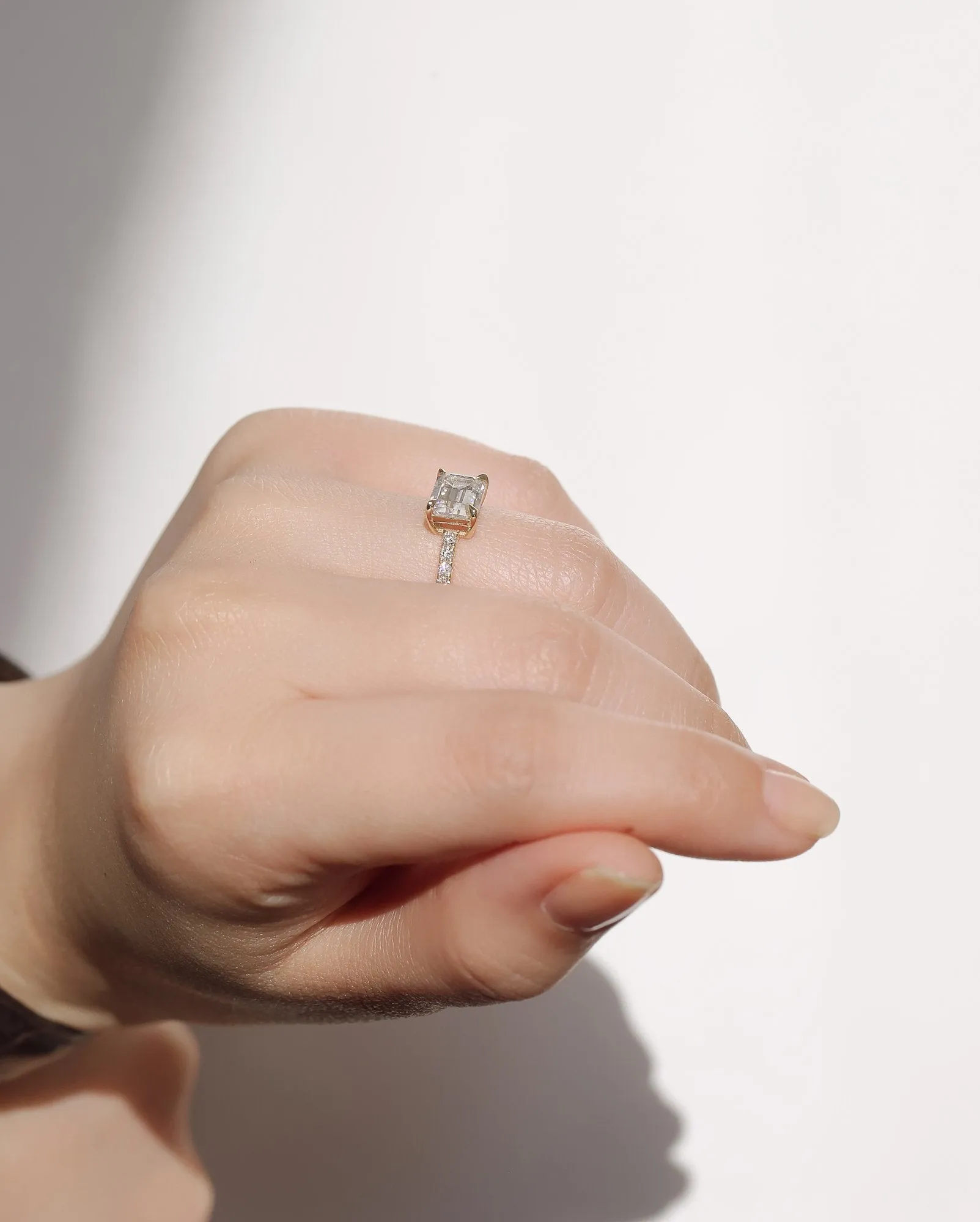 East-West Style Emerald Moissanite Engagement Ring